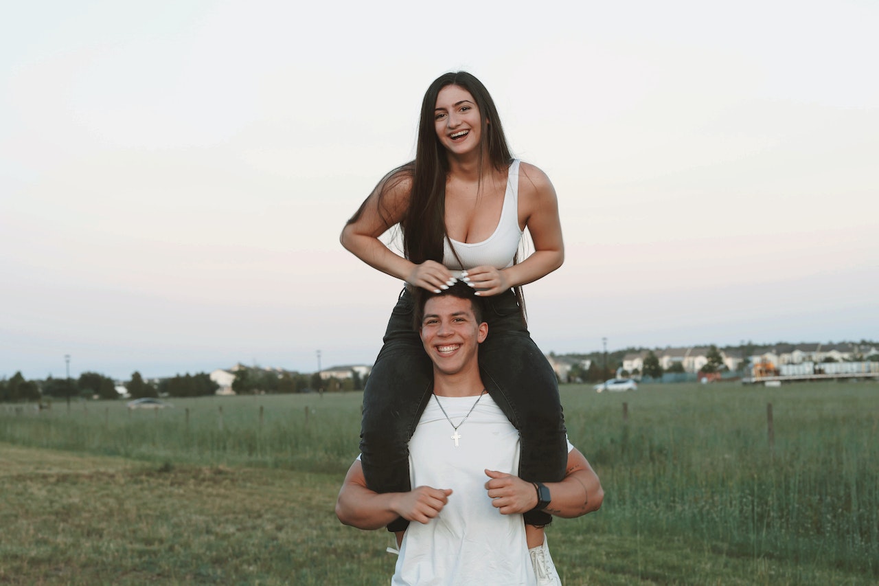 guy carrying a girl on his shoulders