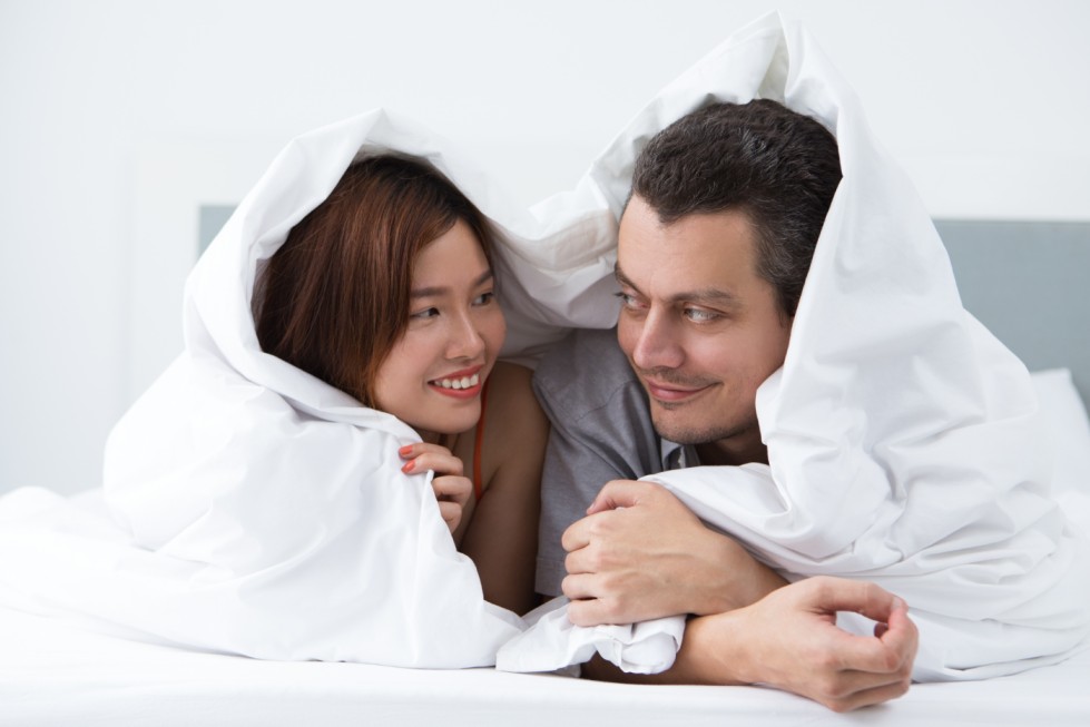 man woman love in bed