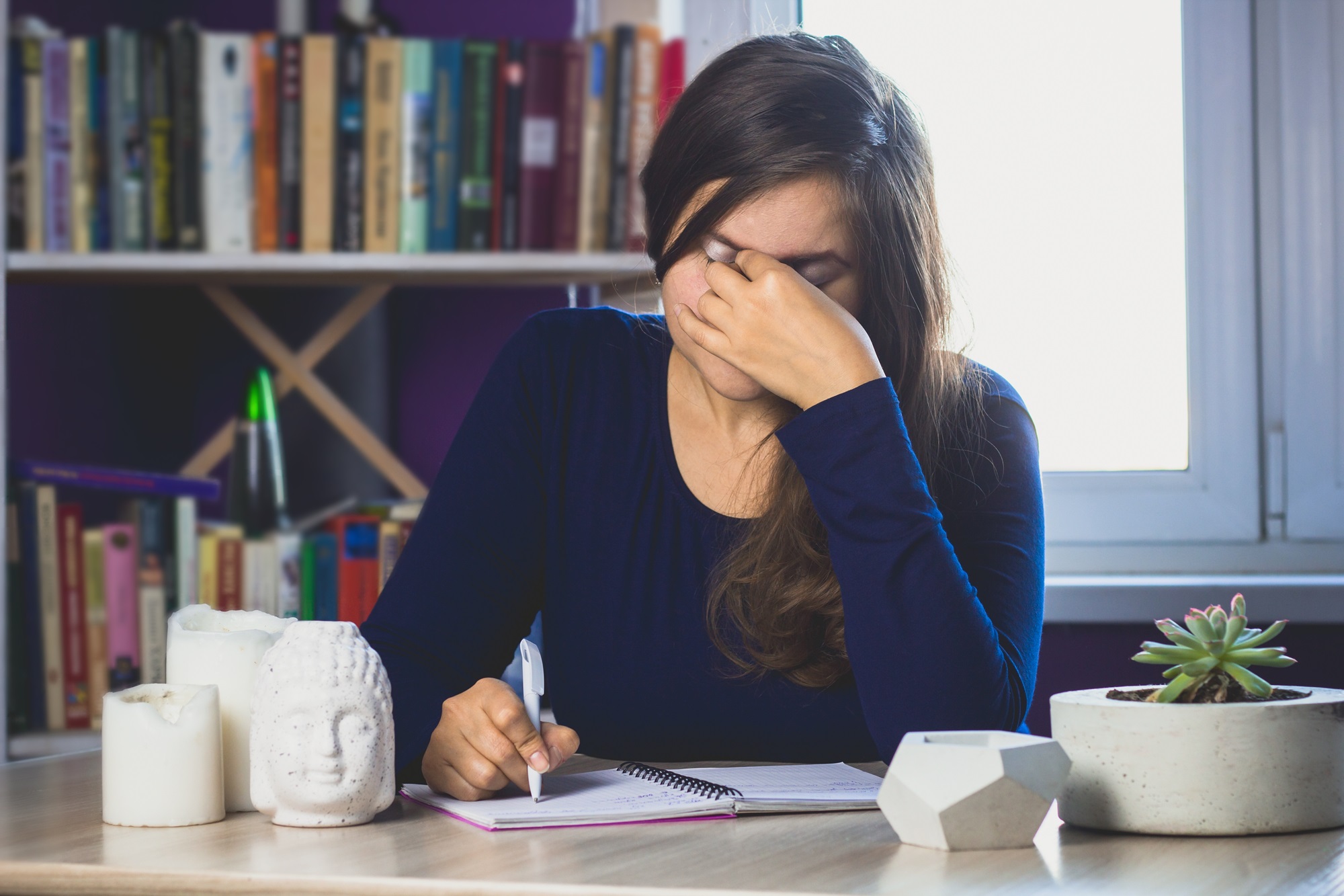 woman writing a letter and crying