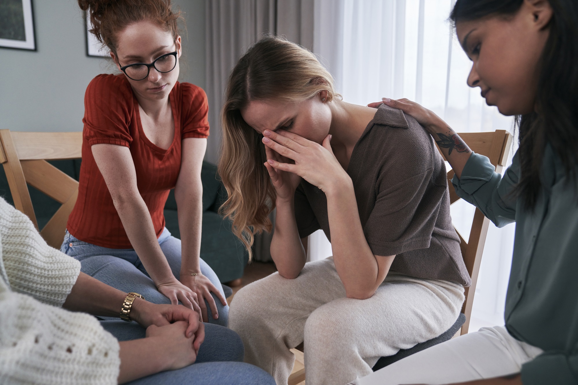 woman crying with friends