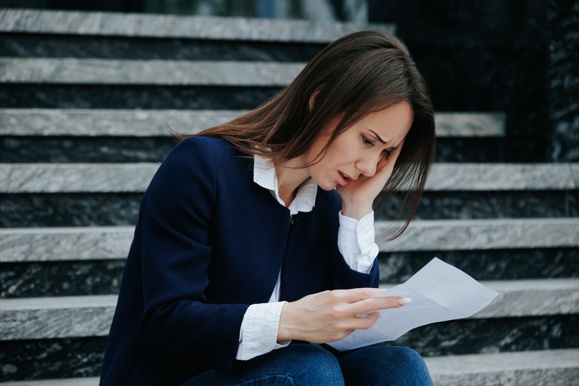 young girl reading a letter and feeling sad