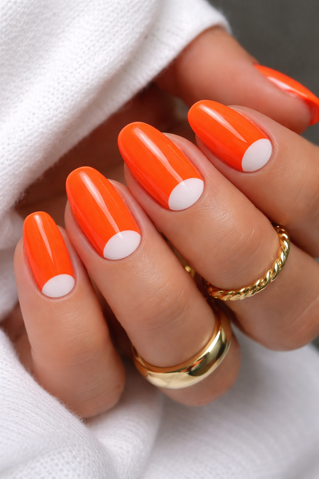 Neon orange with white half-moon nail design
