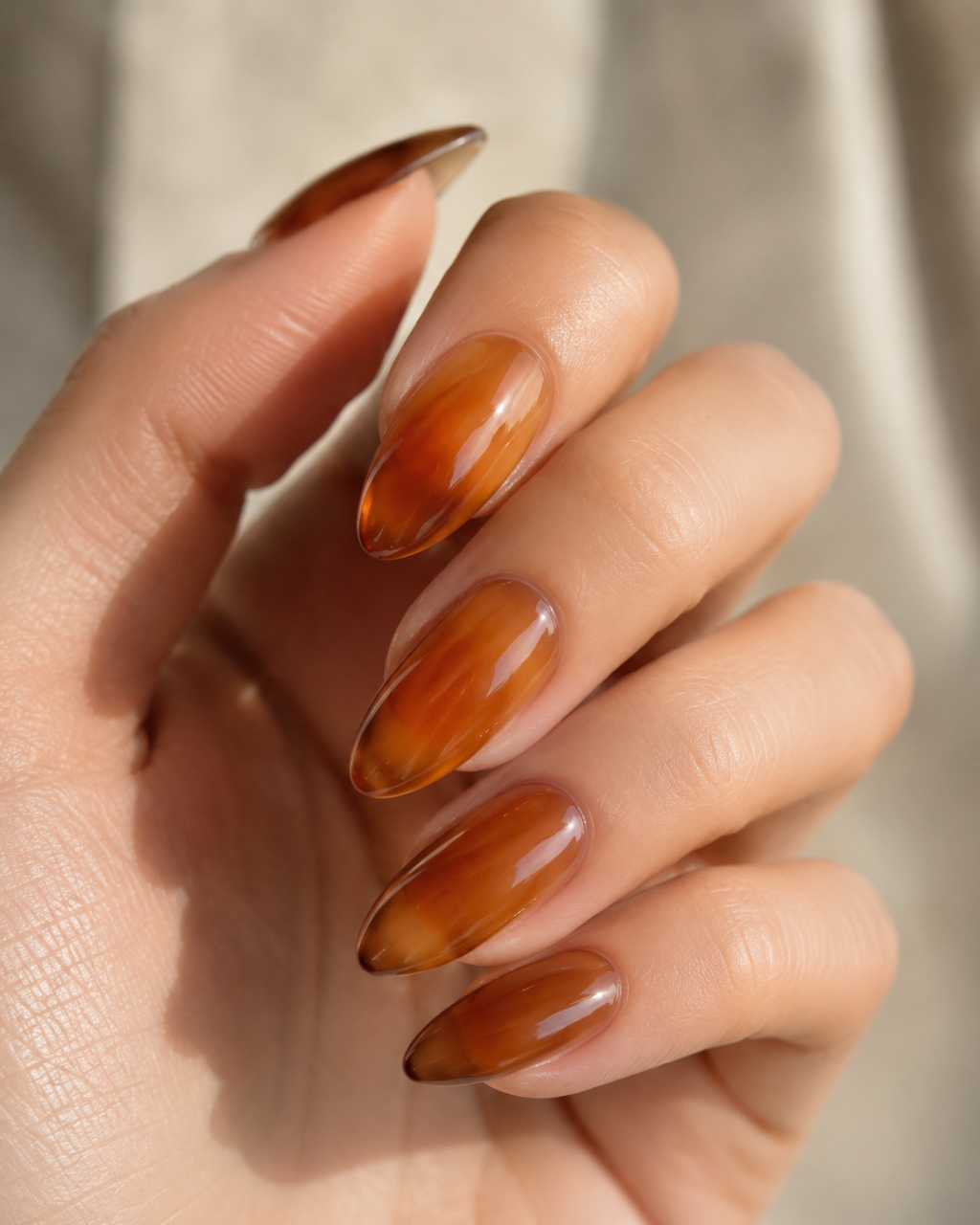 Sheer glassy nails resembling tinted hard candy with a high-shine finish