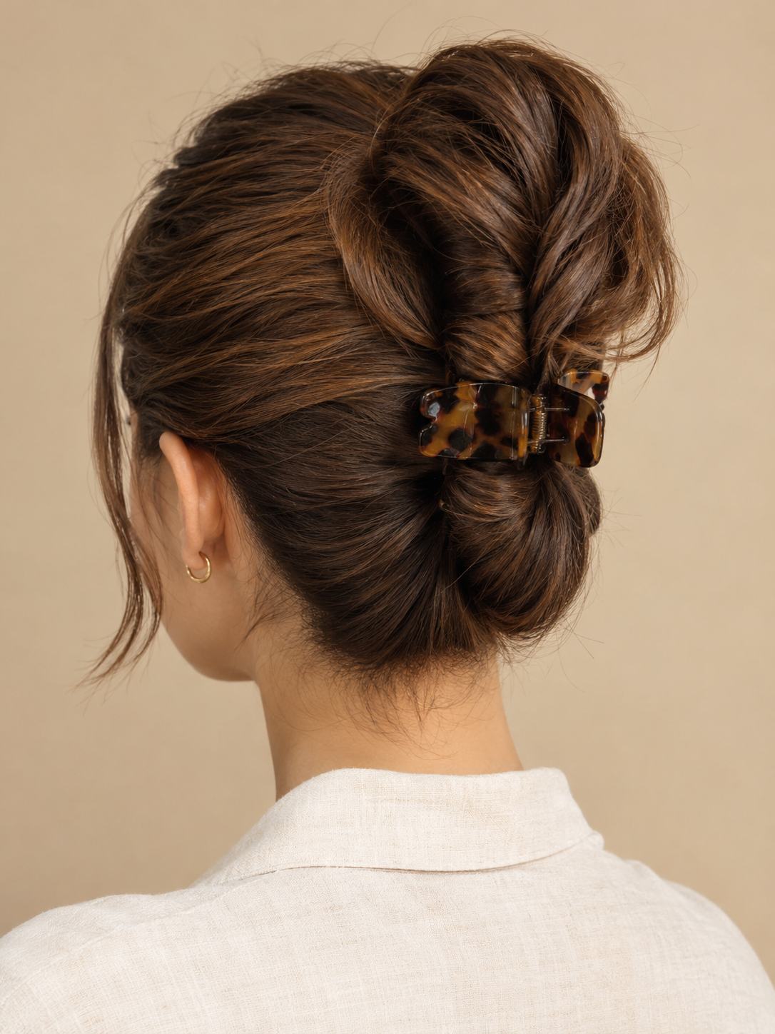 claw clip ponytail twist with the ends draped above the clip